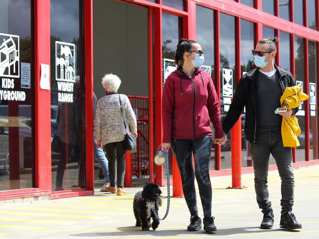 Serena Rampino and her husband Luca Marcante with puppy Milo are seen at Bunnings wearing facemasks. Picture: Gaye Gerard