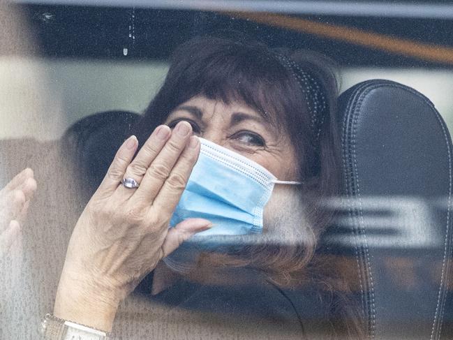 SYDNEY, AUSTRALIA - DECEMBER 03: United Airlines crew members wave and blow kisses as they depart the Novotel Hotel in Darling Harbour on December 03, 2020 in Sydney, Australia. NSW has recorded its first locally acquired COVID-19 case in 26 days after a hotel quarantine worker tested positive for coronavirus. NSW Health is now investigating the case with genome sequencing underway to determine whether the infection was acquired in the community or through work at a hotel quarantine facility. (Photo by Jenny Evans/Getty Images) *** BESTPIX ***