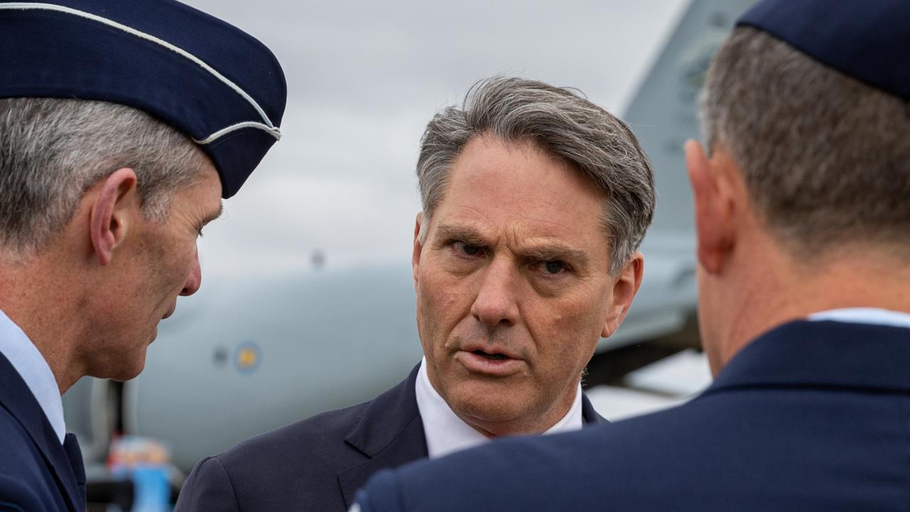 Defence Minister Richard Marles chats with RAAF personnel including Chief of Air Force Robert Chipman, left. Picture: Asanka Ratnayake/Getty Images