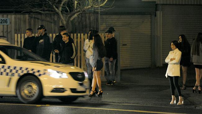 Bystanders outside a party which was gatecrashed. Picture: Andrew Henshaw