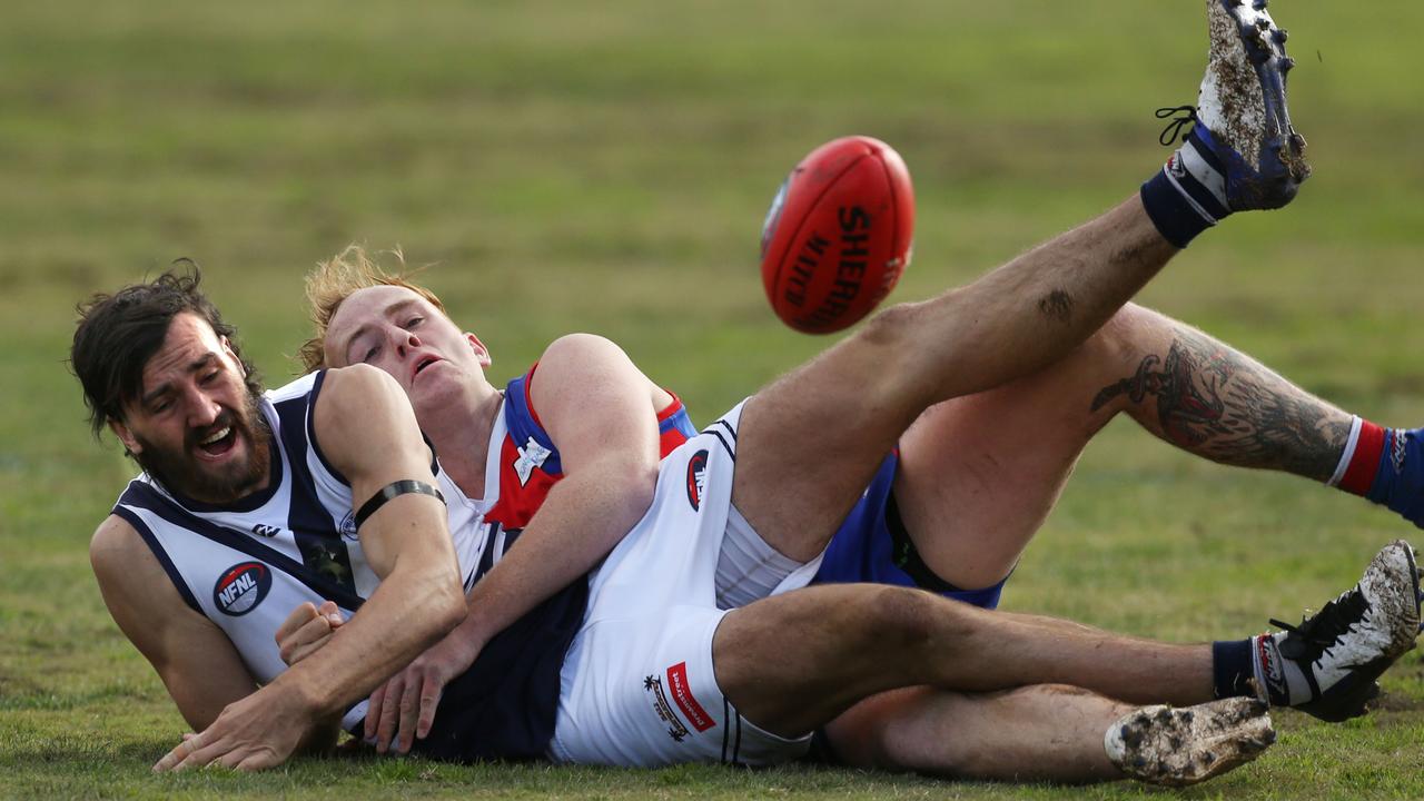 Northern: North Heidelberg’s Mitch Dillon tackles John Jorgensen of Bundoora. Picture: Stuart Milligan