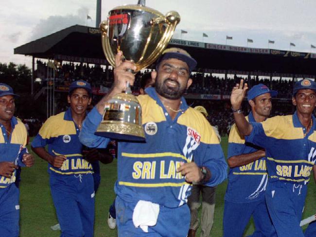 Sri Lanka's Asanka Gurusinha holds the trophy as he and the team celebrate after defeating Australia, final of one day International of 1996 Singer World Series in Colombo, Sri Lanka. Pic Glenn Barnes.         Cricket A/CT