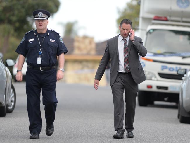 A police detective and officer at the scene. Picture: Campbell Brodie.