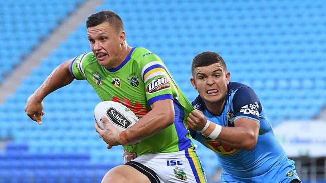 Jack Wighton attempts to break the tackle of Gold Coast’s Ash Taylor. Picture: AAP