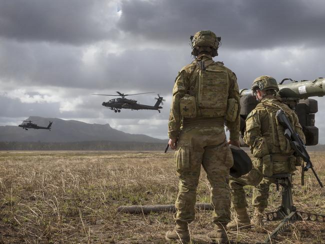 A supplied image obtained on Wednesday, July 10, 2019, of members of 16th Regiment armed with their RBS-70 watch over the battle field as two US Army Apache Attack helicopters demonstrating their capability at Shoalwater Bay Training Area in Queensland. Talisman Sabre 2019 (TS19) is a bilateral combined Australian and United States (US) training activity that around 25,000 Australian and U.S. military personnel will participate in over the next month. (AAP Image/Supplied by The Department Of Defence) NO ARCHIVING, EDITORIAL USE ONLY