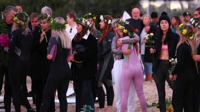 Family and friends at the paddle out. (Photo by Chris Hyde/Getty Images)