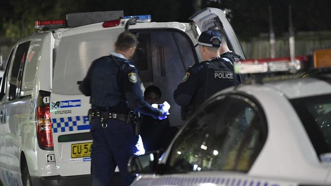 Police talk to a man after the incident overnight. Picture: Gordon McComiskie