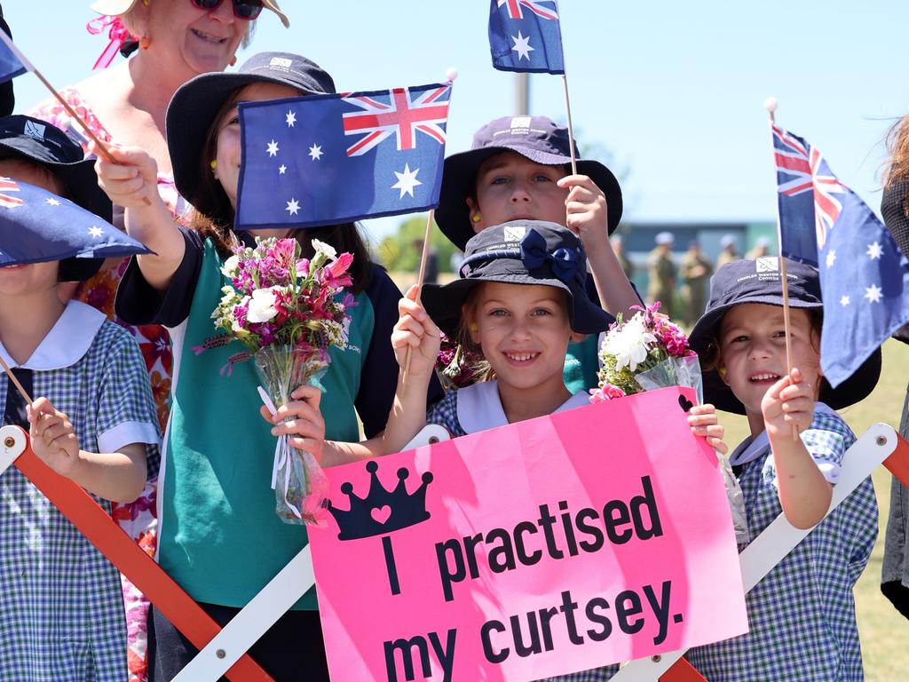 Children wave flags as King Charles III and Queen Camilla arrive in Canberra. Picture: Chris Jackson/Getty Images