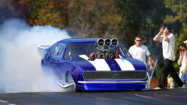 race car reving it up and burning rubber at the dragstrip