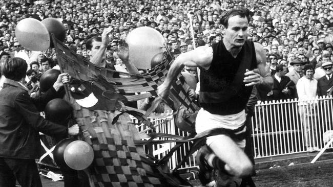 Walls’ childhood hero Ken Fraser leads Essendon out onto the ground in 1968 — a week after whacking the young Carlton player.