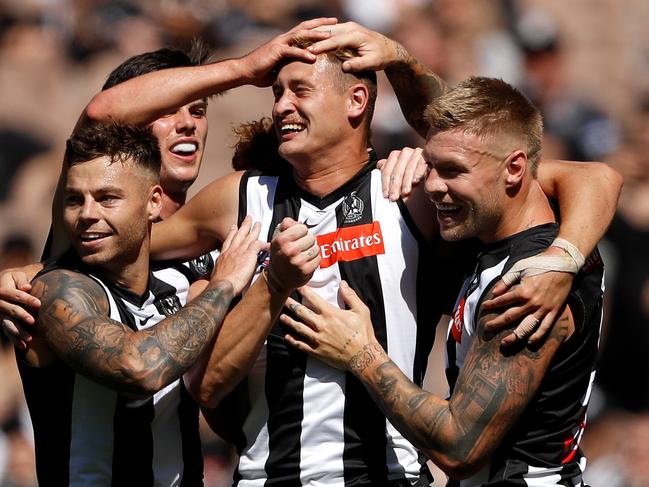 MELBOURNE, AUSTRALIA - MARCH 26: Nathan Kreuger of the Magpies celebrates a goal with Jamie Elliott, Oliver Henry and Jordan De Goey of the Magpies during the 2022 AFL Round 02 match between the Collingwood Magpies and the Adelaide Crows at the Melbourne Cricket Ground on March 26, 2022 In Melbourne, Australia. (Photo by Dylan Burns/AFL Photos via Getty Images)