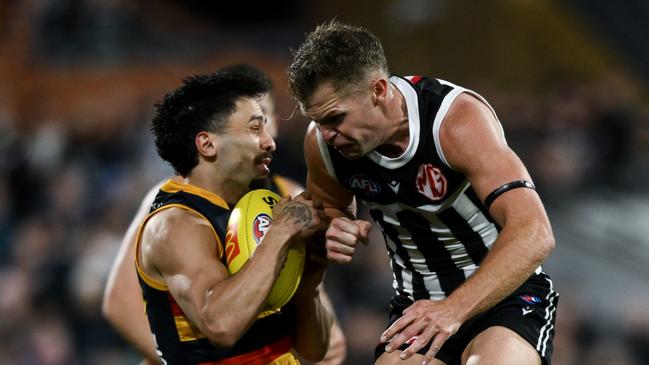 ADELAIDE, AUSTRALIA - AUGUST 17:   Izak Rankine of the Crows is knocked out by  a late hit from  Dan Houston of the Power during the round 23 AFL match between Port Adelaide Power and Adelaide Crows at Adelaide Oval, on August 17, 2024, in Adelaide, Australia. (Photo by Mark Brake/Getty Images)