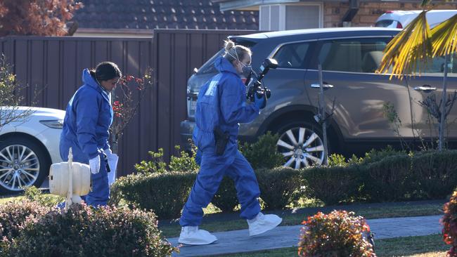 Forensic officers arrive at the St Clair house yesterday morning. Picture: David Swift.