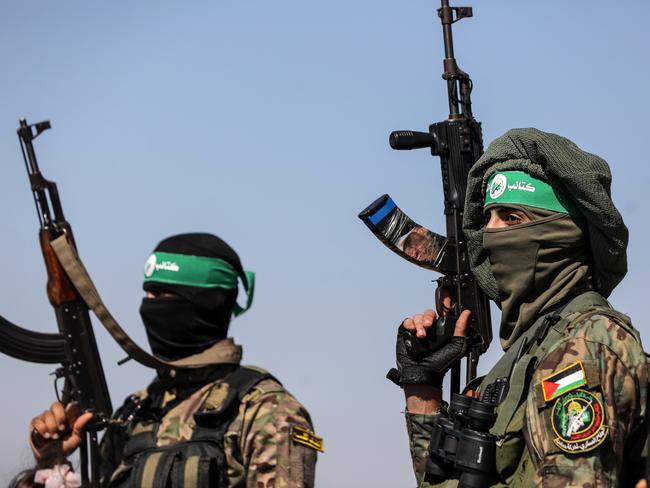 Palestinian fighters from the armed wing of Hamas are taking part in a military parade in front of an Israeli military site to mark the anniversary of the 2014 war with Israel, near the border in the central Gaza Strip, on July 19, 2023. (Photo by Majdi Fathi/NurPhoto via Getty Images)