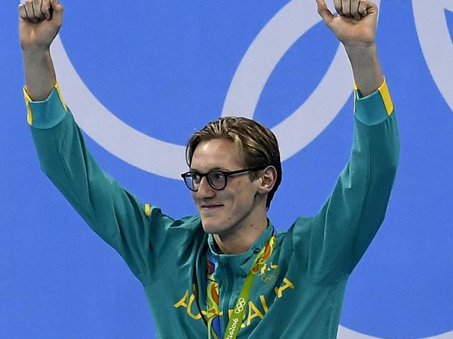 Australia's Mack Horton celebrates on the podium with his gold medal after he won the Men's 400m Freestyle Final during the swimming event at the Rio 2016 Olympic Games at the Olympic Aquatics Stadium in Rio de Janeiro on August 6, 2016. / AFP PHOTO / GABRIEL BOUYS