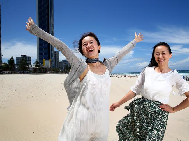 Chinese Tourists Qiqi Si and Nana Chao enjoy time on Surfers Paradise Beach. Picture: Adam Head