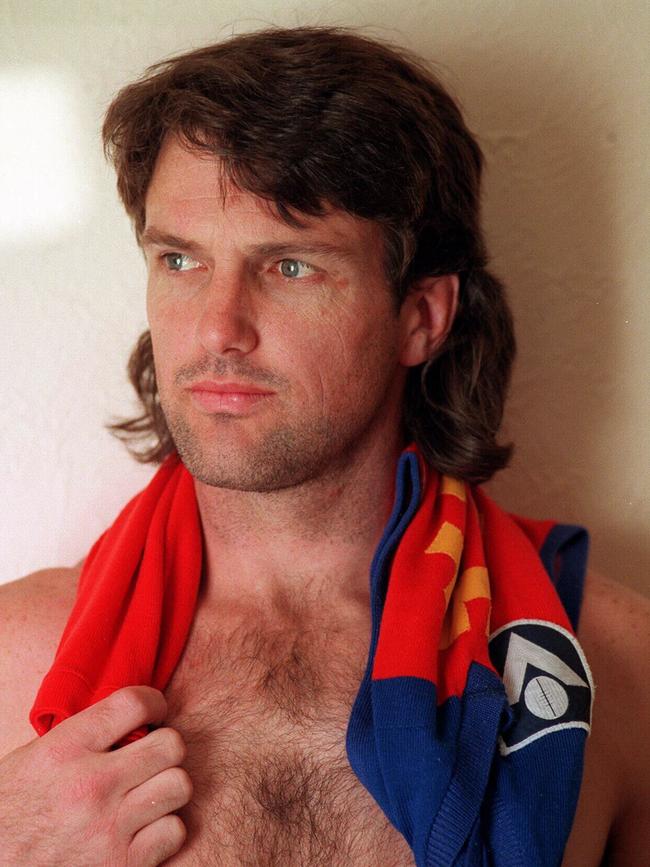 Paul Roos draped in a Fitzroy jumper.