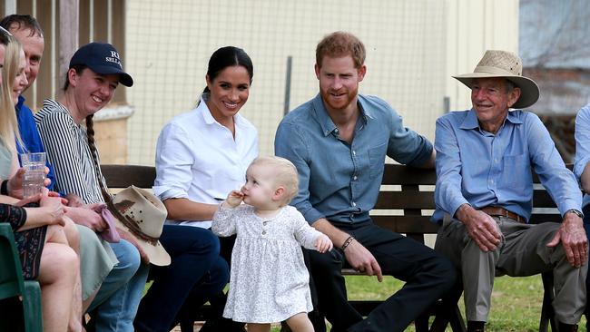 One-year-old Ruby Carroll brings a smile to the faces of Meghan and Prince Harry. Picture: Toby Zerna