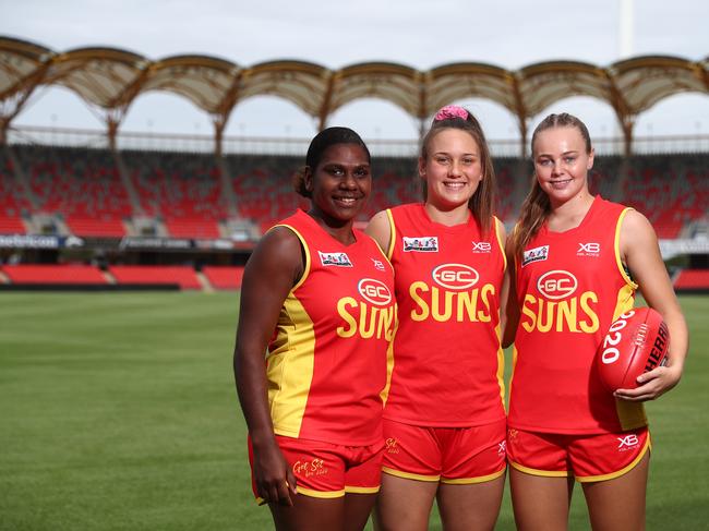 (L-R) Kitara Whap-Farrar, Ellie Hampson and Charlotte Hammans come together for the first time since signing for the Gold Coast Suns AFLW team. Picture: Chris Hyde/Getty Images.