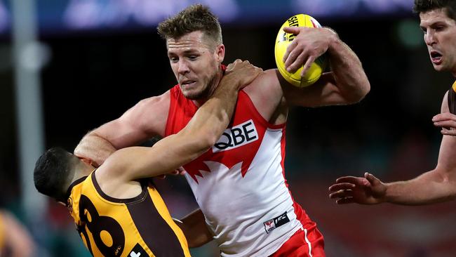 Hawthorn's Paul Puopolo tackles Sydney's Luke Parker during a game against the Swans. Picture. Phil Hillyard