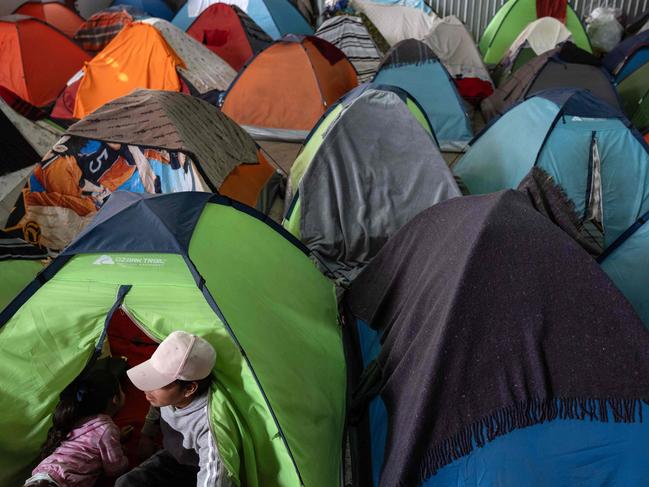 An asylum seeker sits in the tent he occupies at a migrant shelter in Tijuana, Baja California state, Mexico. Picture: AFP