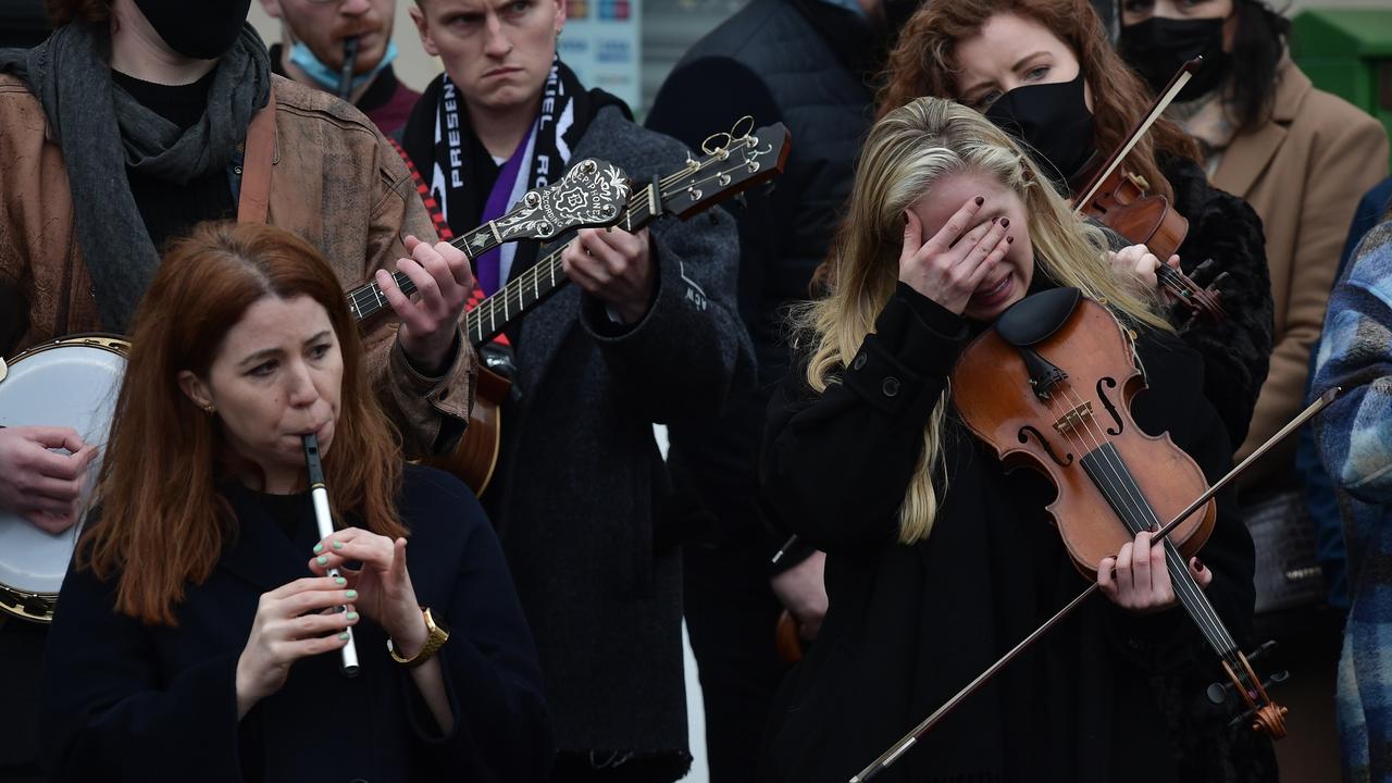 A musician becomes emotional as she performs during the funeral. Picture: Charles McQuillan/Getty Images