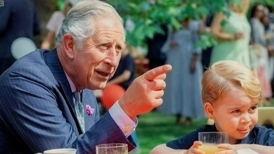 Prince George with his grandfather in a never-before-seen photo. Picture: BBC