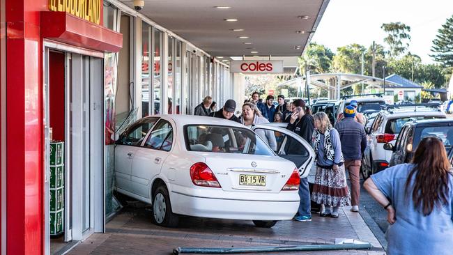 Coles crash: People assist an elderly driver who drove into the front door of Coles at Umina Beach. Picture: Gary Brown.