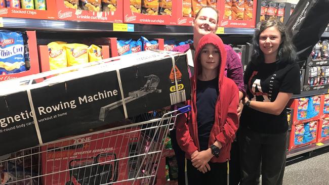 Kylie, Vaughan and Willow Siebenhausen from Ambrose at the Aldi opening with a rowing machine, generator and roller.