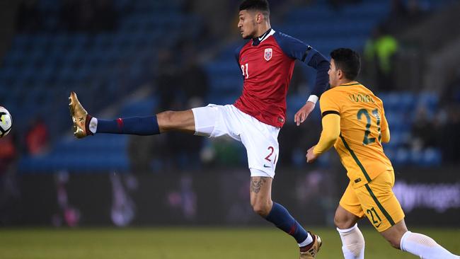 Birger Meling of Norway stretches for the ball ahead of Massimo Luongo of Australia