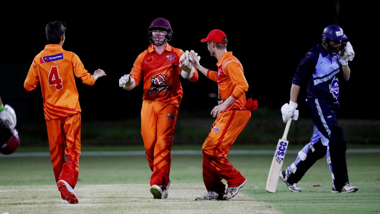 Barrier Reef Big Bash Game 1: Badgers v Hurricanes at Griffiths Park. Badgers' Aidan Beach, Angus Warnock and Daniel Freebody celebrate the wicket of Hurricanes' Mark Ellis. Picture: Stewart McLean