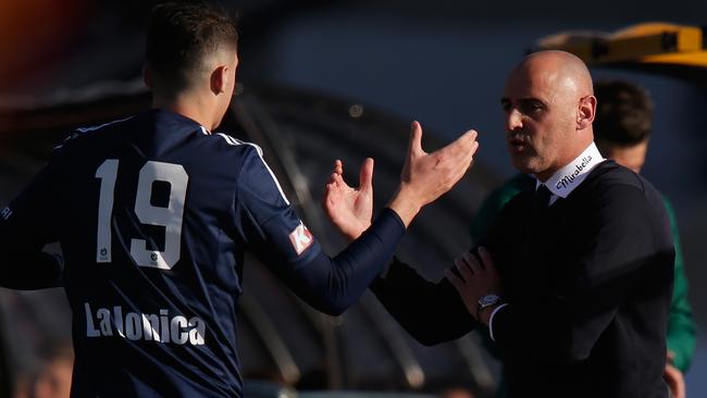 George Howard of the Victory high fives coach Kevin Muscat.