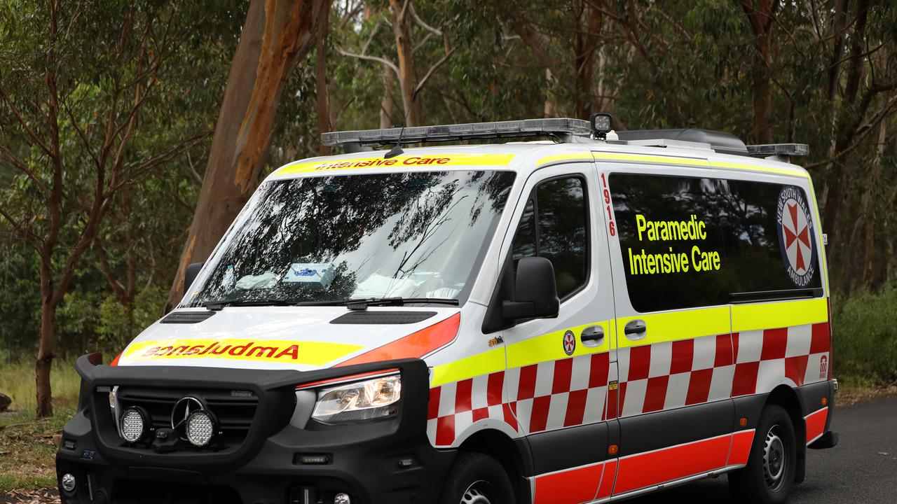 SYDNEY, AUSTRALIA - NewsWire Photos JANUARY 20, 2021: An ambulance passes by a police road block near Keith Longhurst Reserve near where a police search is underway on the Georges river for a 15-year-old teenage boy believed to have drowned while swimming. Picture: NCA NewsWire / Damian Shaw