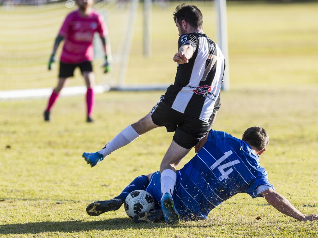 Ryan Crawford (left) of Willowburn is tackled by Brendan Willmot of Rockville Rovers in Toowoomba Football League Premier Men round 13 at Captain Cook reserve, Sunday, June 20, 2021. Picture: Kevin Farmer