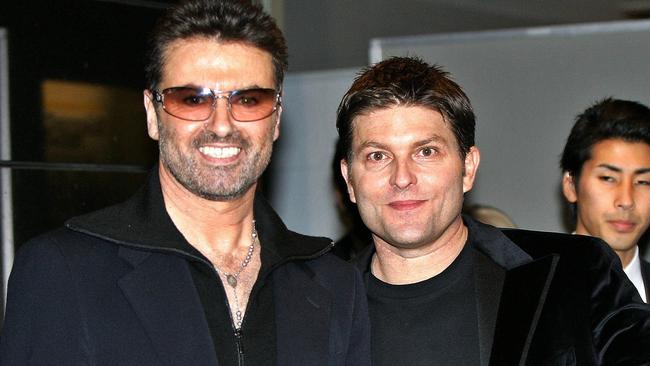 British pop star George Michael (L) with his partner Kenny Goss. Picture: AP.