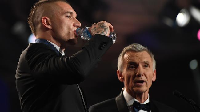 Dustin Martin takes a sip of water during his acceptance speech.