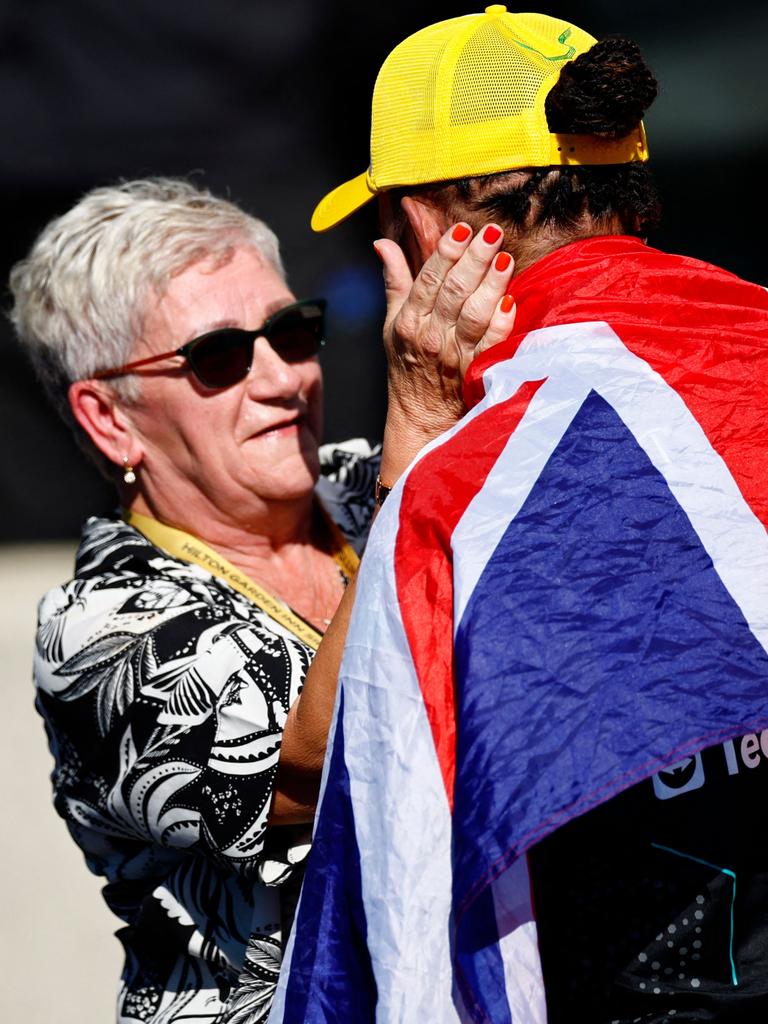 Hamilton celebrates with his mother Carmen Larbalestier. (Photo by BENJAMIN CREMEL / AFP)