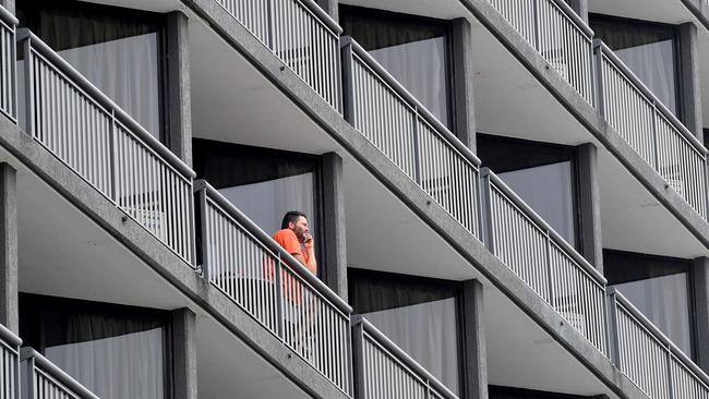 A man on the balcony of Brisbanes quarantine hotel The Grand Chancellor, Spring Hill Queensland. Picture: NewsWire / John Gass POOL via NCA NewsWire