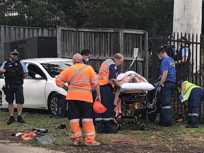 The man had been pinned by his legs when the left side of the car hot the school fence. Picture: Jim O'Rourke