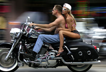 Summer days ... gunning a Harley along Daytona Beach / AP