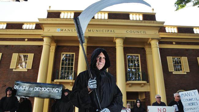 Locals from the Save Manly Oval Alliance protest outside Manly Council Chambers, and Manly Oval dressed in black with the Grim Reaper, pallbearers and an special coffin. Picture: Braden Fastier