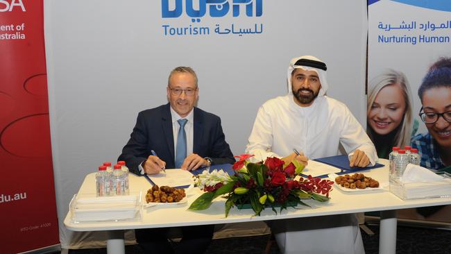 Ex-TAFE SA chief executive Robin Murt signs an agreement with Issam Kazim, chief executive of Dubai Corporation for Tourism and Commerce Marketing in Dubai.