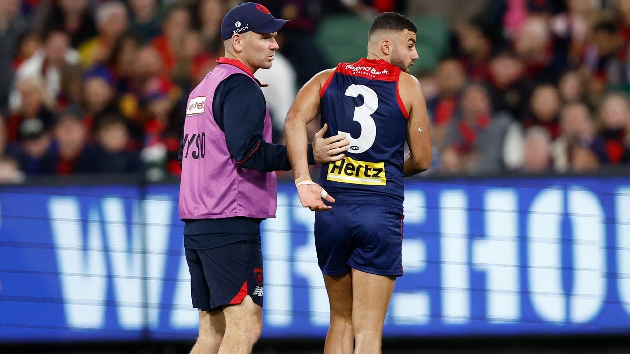 Christian Salem helped from the field after picking up a hamstring injury. (Photo by Michael Willson/AFL Photos via Getty Images)