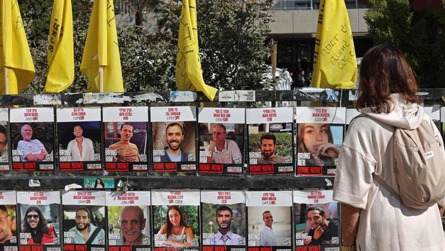 A woman in Tel Aviv looks at the portraits of Israeli hostages held in the Gaza Strip since the October 7, 2023, attacks by Hamas militants. Picture: AFP