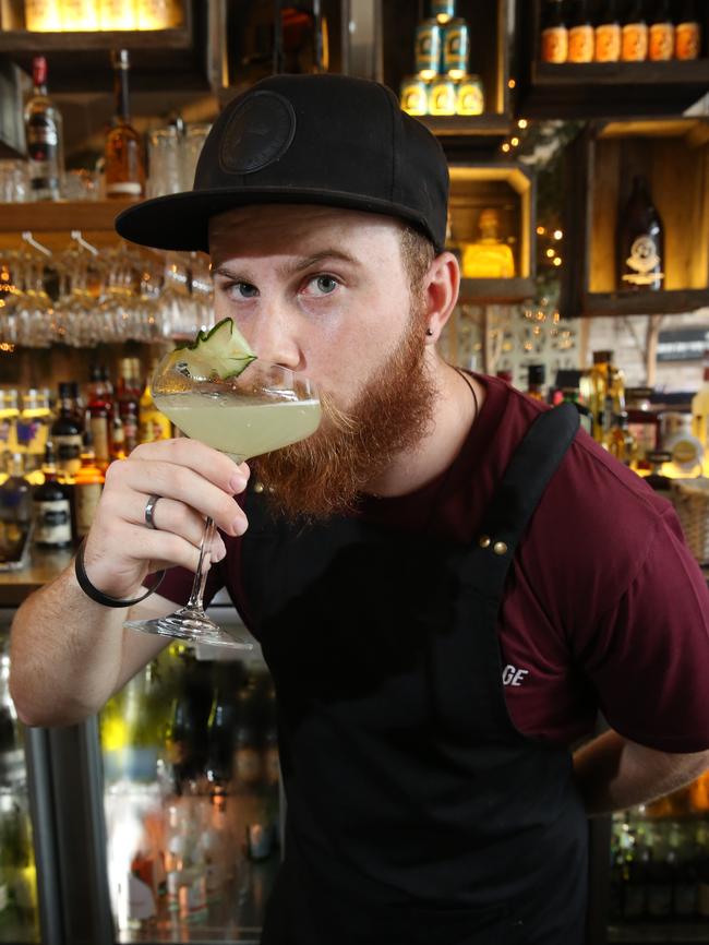 Bartender Luke Muller sips a vera green cocktail.