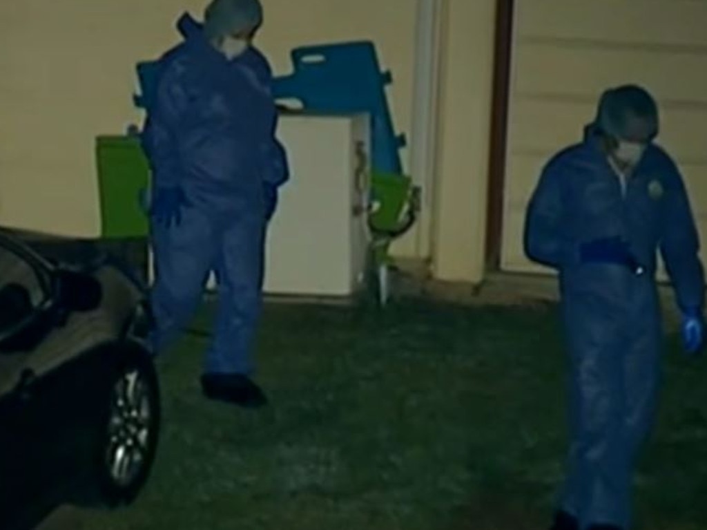 Police comb the scene outside the North Ipswich home where Warren Toby’s body was found just after midnight.