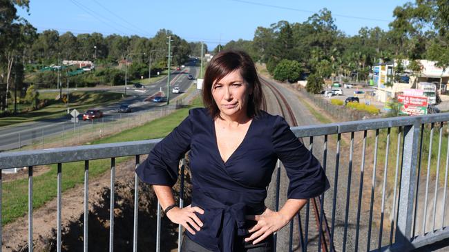 Member for Algester Leeanne Enoch with the rail line behind her.