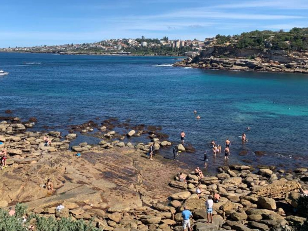 Dozens of swimmers in the water near the Clovelly car park off the rocks in Gordon’s Bay