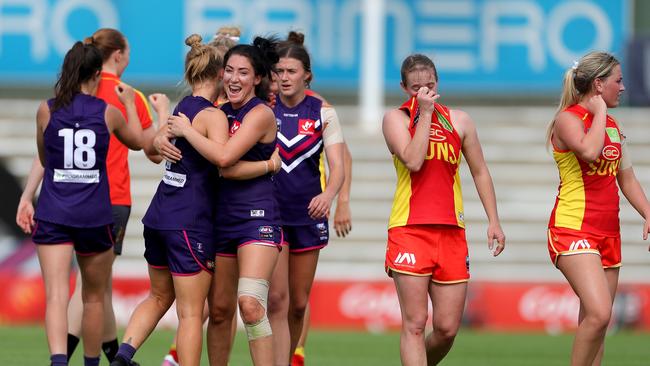 Dockers players celebrate after winning the AFLW semi final 4 match between the Fremantle Dockers and Gold Coast Suns at Fremantle Oval in Perth, Saturday, March 21, 2020. (AAP Image/Richard Wainwright)