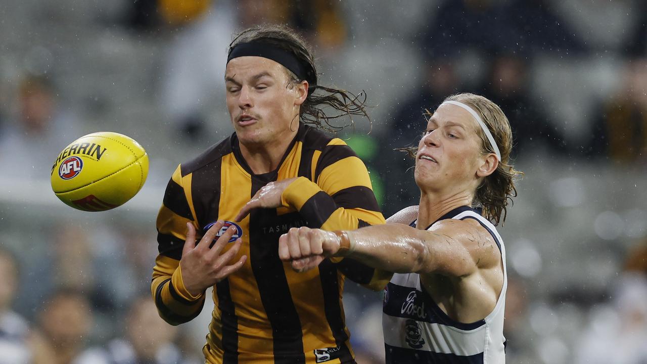 MELBOURNE , AUSTRALIA. April 1, 2024. AFL Round 3. Hawthorn vs Geelong at the MCG. Sam De Koning of the Cats spoils the ball away from Jack Ginnivan of the Hawks . Pic: Michael Klein